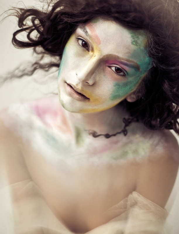 Brunette female model with pale face and colorful makeup by Nika Vaughan
