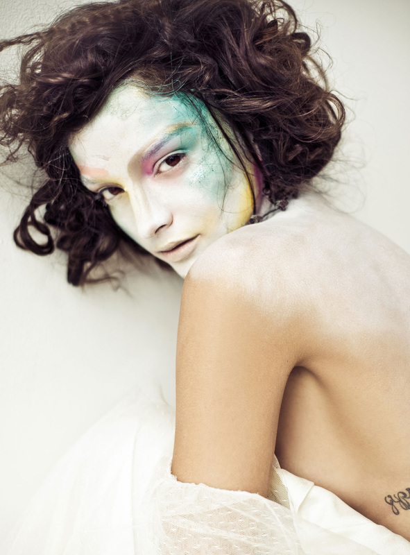 Model with pale face and colorful makeup by Nika Vaughan